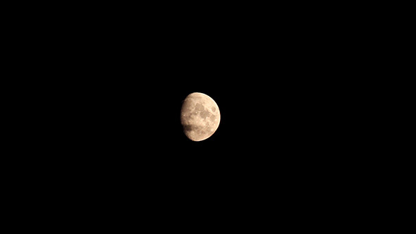 Moon In The Night Sky Between Clouds