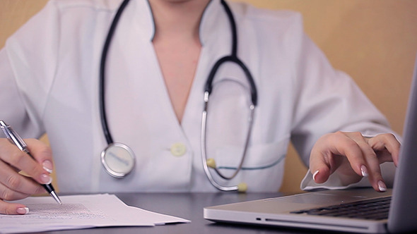 Doctor Using Laptop And Keeps Notes 