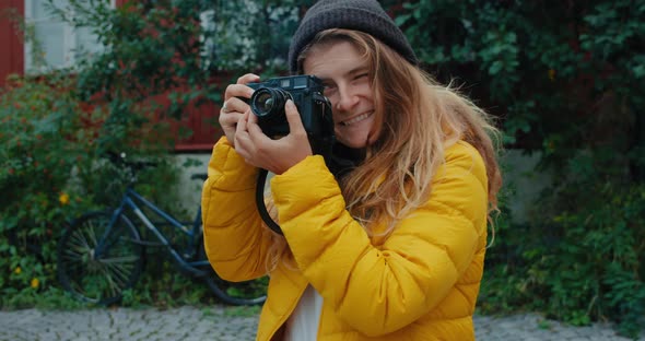 Portrait of Pretty Millennial with Analog Camera