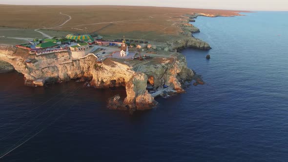 Drone View of the Coastline with Sheer White Rocks at Sunset