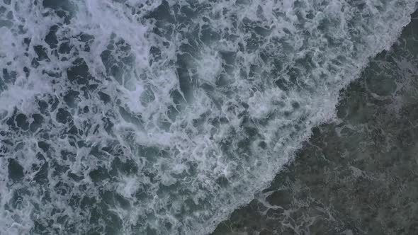 Drone view from above of clear water crashing in waves La Digue Seychelles