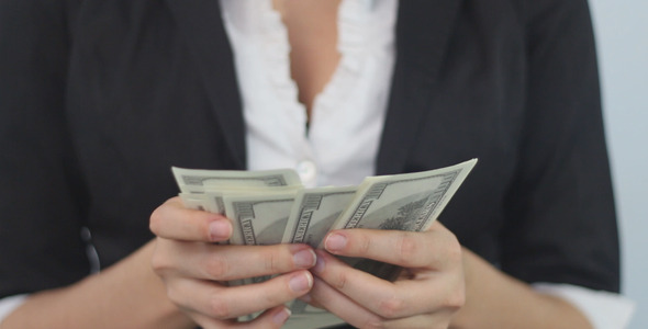 Dollars in the Hands of a Businesswoman
