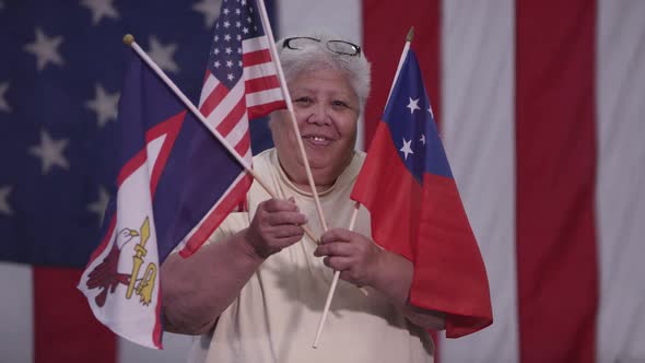 Woman holding Flag of Samoa and American Flags