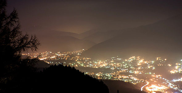 City Under the Mountain With Fog in the Night