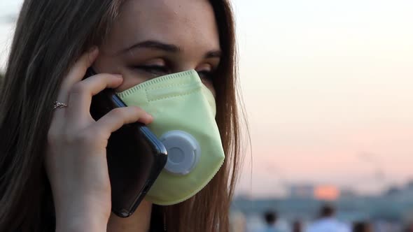 Woman in Medical Mask Speaks on the Phone