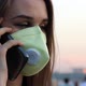 Woman in Medical Mask Speaks on the Phone - VideoHive Item for Sale
