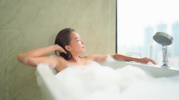 Young asian woman relax in bathtub