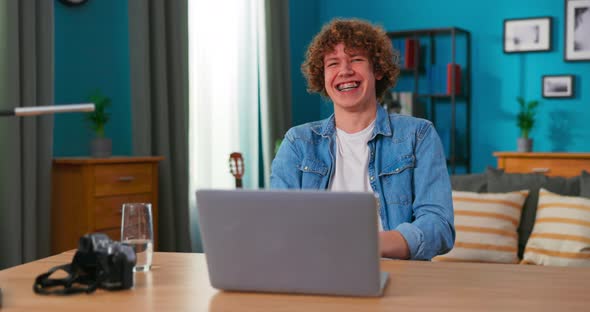 Successful Teenage Boy Sits at Table Uses Laptop Read Emails Online Home Office Gets Good