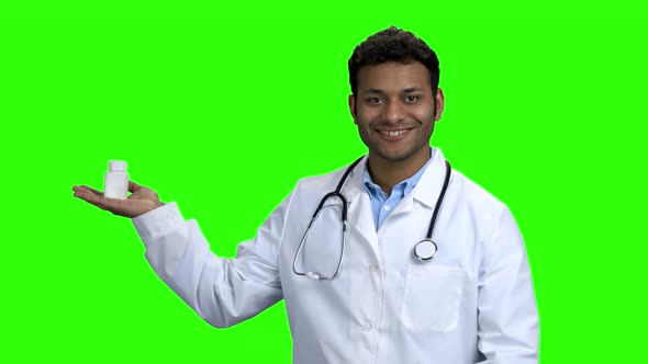 Young Male Doctor Presenting Pills on Green Screen