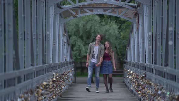 Young couple walking on a bridge