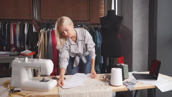 Woman Measuring Fabric for New Clothes