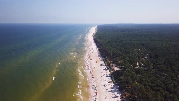 Drone footage of a sandy beach, sunny summer day, Baltic Sea, Poland, Lubiatowo.