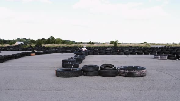 Male Racer in Protective Helmet Racing on the Go-kart Track Outdoors