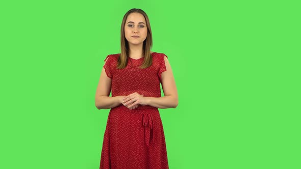 Tender Girl in Red Dress Is Reporting and Telling a Lot of Interesting Information. Green Screen
