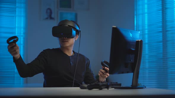 Asian young man playing video game in virtual reality headset _ 47