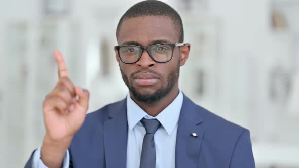 Portrait of African Businessman Saying No By Finger Sign 