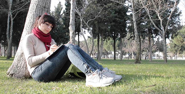  Young Girl Writing in the Park