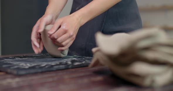 Female Sculptor Kneads Clay with Her Hands to Create Ceramics in Her Workshop