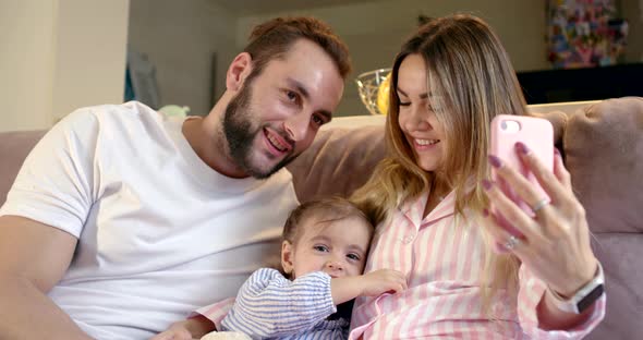 Married Couple and Their Little Daughter Are Filming Themselves By Smartphone at Home