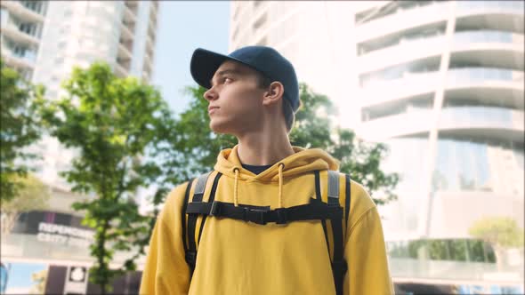 Courier Man Portrait with Yellow Uniform and Backpack Outdoors