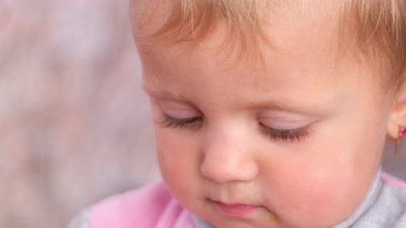 Close Up Portrait of a Cute Sad Baby with Big Eyes