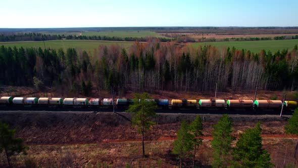 A Long Train with Round Train Car Wagons for Gasoline and Fuel