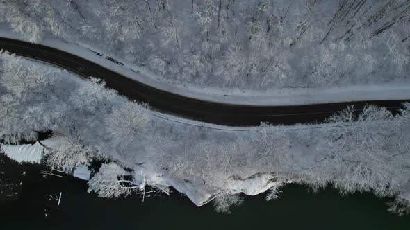 Aerial Top Down Cinematic Winter Snow Cowered Country Road Asphalt Serpentine