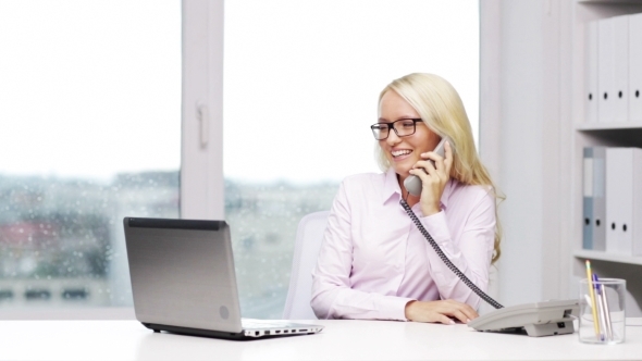 Smiling Businesswoman With Laptop Calling On Phone
