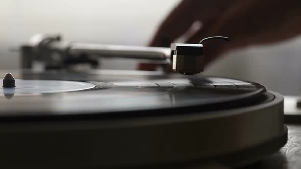 Turntable Player Dropping Stylus Needle on Vinyl Record Playing