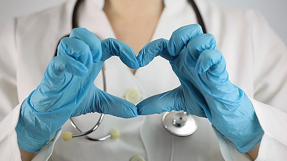Female Doctor Showing Fingers Heart