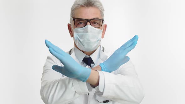 Male Medical Worker Wearing Glasses with Doctor Gloves and Stethoscope and a Medical Gown Crossed