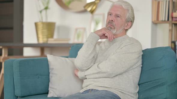 Old Man Thinking While Sitting on Sofa