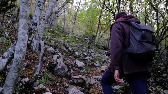 Traveler Guy Walks in Picturesque Place of Wildlife and Looks at Autumn Landscape