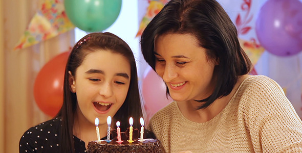 Mother and Daughter with Birthday Cake alt