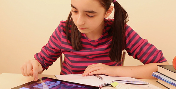 Schoolgirl Doing Her Homework with Digital Tablet