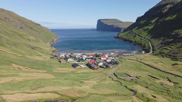 Drone Shot of Small Houses By the Ocean Waters in Tjornuvik Faroe Islands