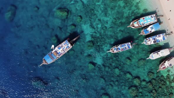 Top View of Yachts in Clear Turquoise Water on the Coast of the Island of Suluada and Vacationers on