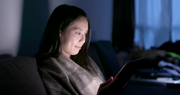 Woman use of smart phone in the evening at home