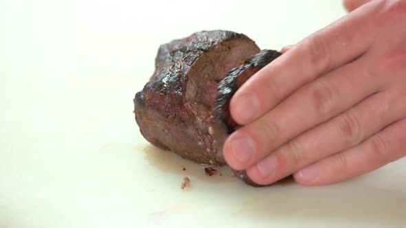 Hands Cutting Tenderloin Steak