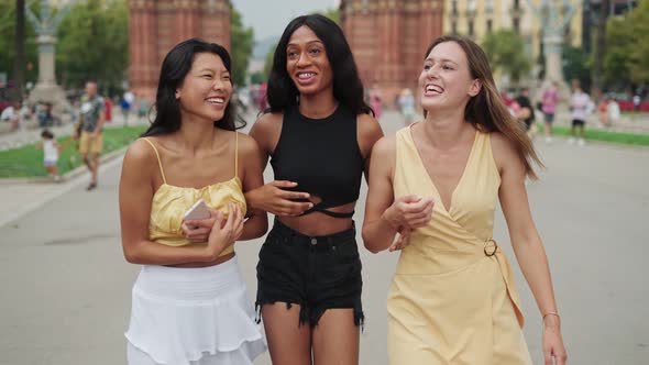 Happy Diverse Female Friends Tourists Walking on Street in City During Travel Trip