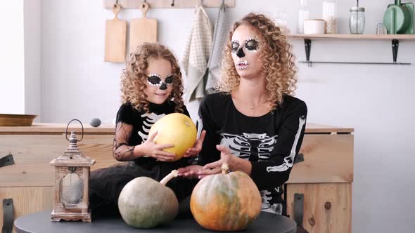 Mother and Daughter with Curly Hair Wearing Halloween Costumes