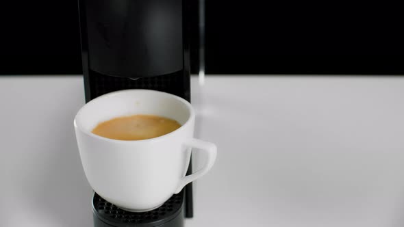 Close-up View of Hand Taking Fresh Coffee From Coffee Machine