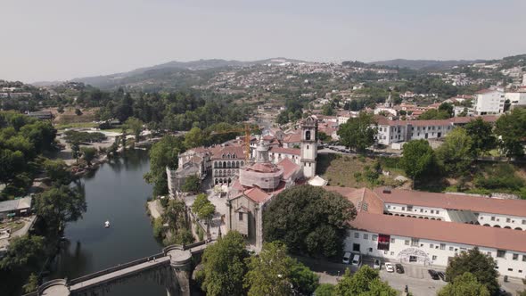 Establishing shot featuring Sao Goncalo monastery, tamega river and mountainous landscape.