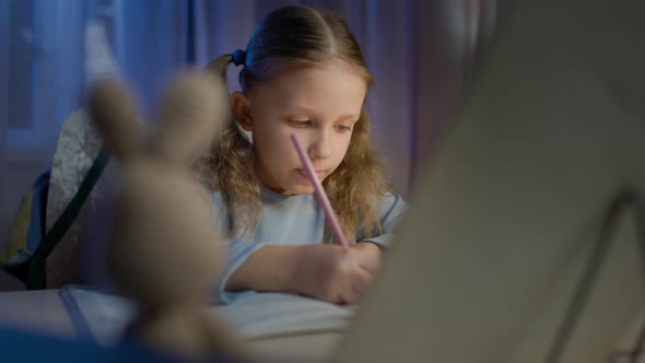 Schoolgirl Junior School Does Homework In The Evening