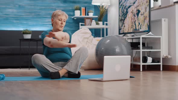 Elder Woman Doing Workout Acitvity on Yoga Mat at Home