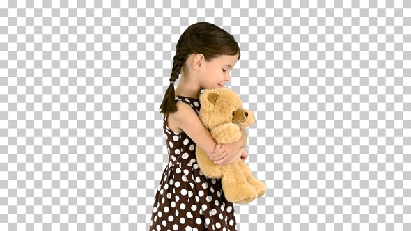 Little girl in polka dot dress hugging, Alpha Channel