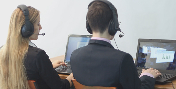 Call Center Operators Working With Laptop