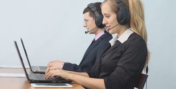 Two Call Center Operators Talking With Clients