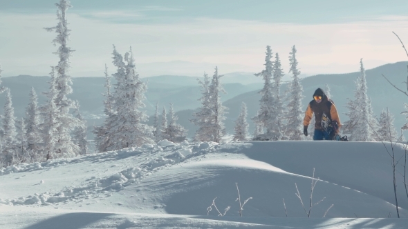 Man Carrying Snowboard 