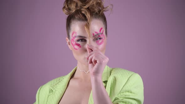 Young Beautiful Woman Professional Make Up Artist with Lipstick Marks Smile at Pink Background